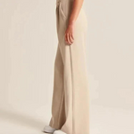 Wide-leg trousers in cream featuring elegant proportions and comfortable everyday wear.