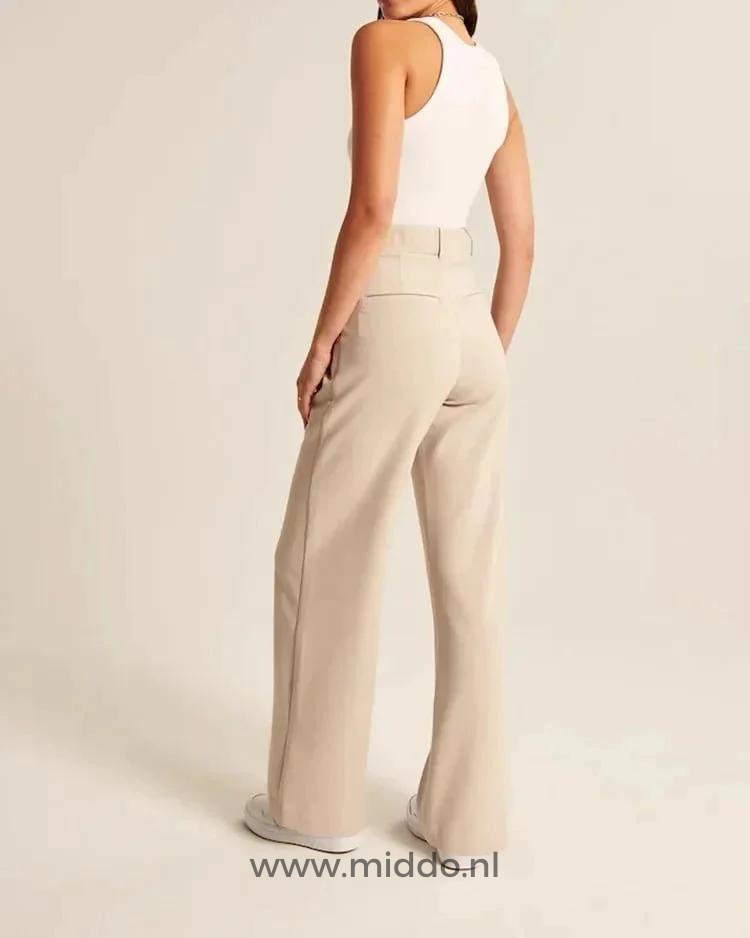 Cream-colored wide-leg trousers worn with effortless styling for all-day comfort.