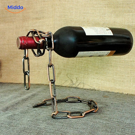 Suspended wine bottle holder with rose gold chain.