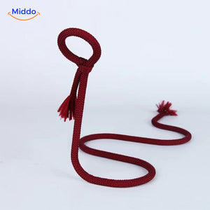 Wine bottle holder with red rope and decorative tassel.