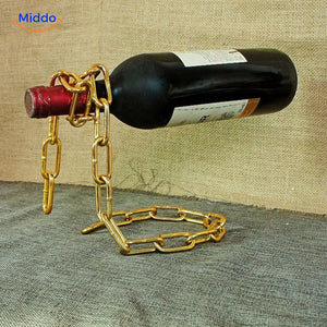 Wine bottle holder featuring elegant gold chain suspension.