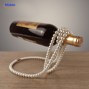Wine bottle holder adorned with white pearl beads.