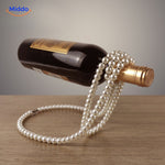 Wine bottle holder adorned with white pearl beads.