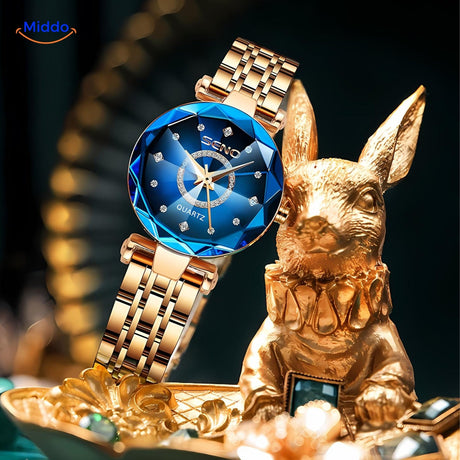 Women's elegance stainless steel watch with gold case and leather strap, clean product photo.