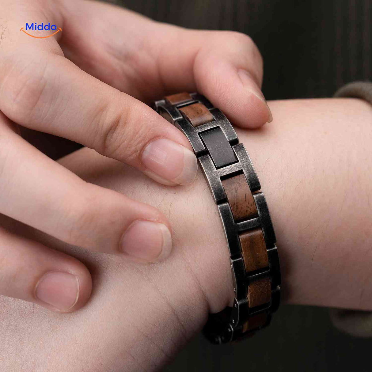 Close-up detail of the secure metal closure mechanism on wooden bracelet.