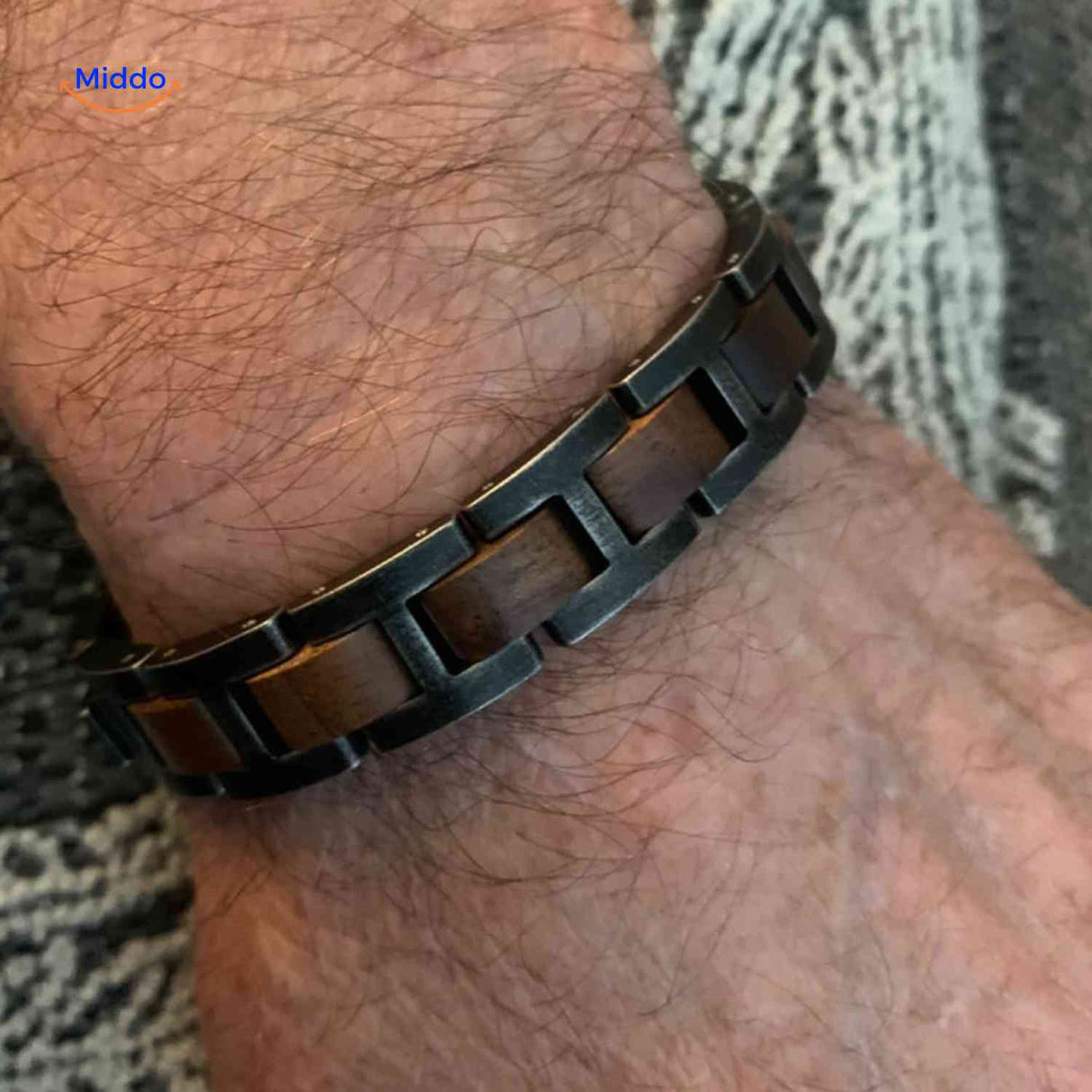 Lifestyle image of man wearing wooden metal bracelet in everyday setting.