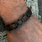 Lifestyle image of man wearing wooden metal bracelet in everyday setting.