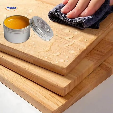 Furniture balm applied to wooden surface to restore shine and remove scratches.