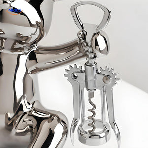 Close-up of the bear-shaped bottle opener mechanism on the rustic wooden wine holder.