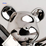 Detail close-up of the handcrafted wooden bear wine holder showing wood grain texture and carved features.