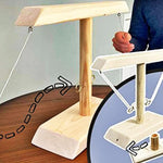 Wooden ring toss game featuring white wooden base and pole structure.