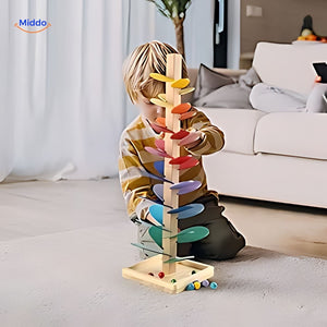 Child playing with wooden ball run tree in home setting.