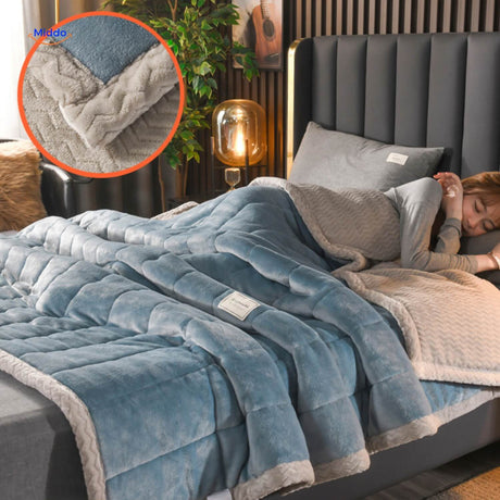 Light blue and grey two-tone wool blanket displayed on bed.