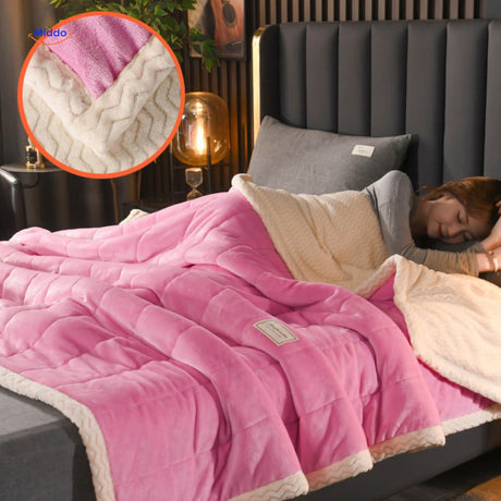 Light rose and white plush fleece blanket on bed styling.