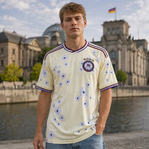Germany cream colored World Cup supporter jersey with national colors.