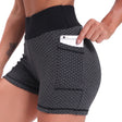 Black high-waisted yoga shorts with jacquard texture and breathable lift support.