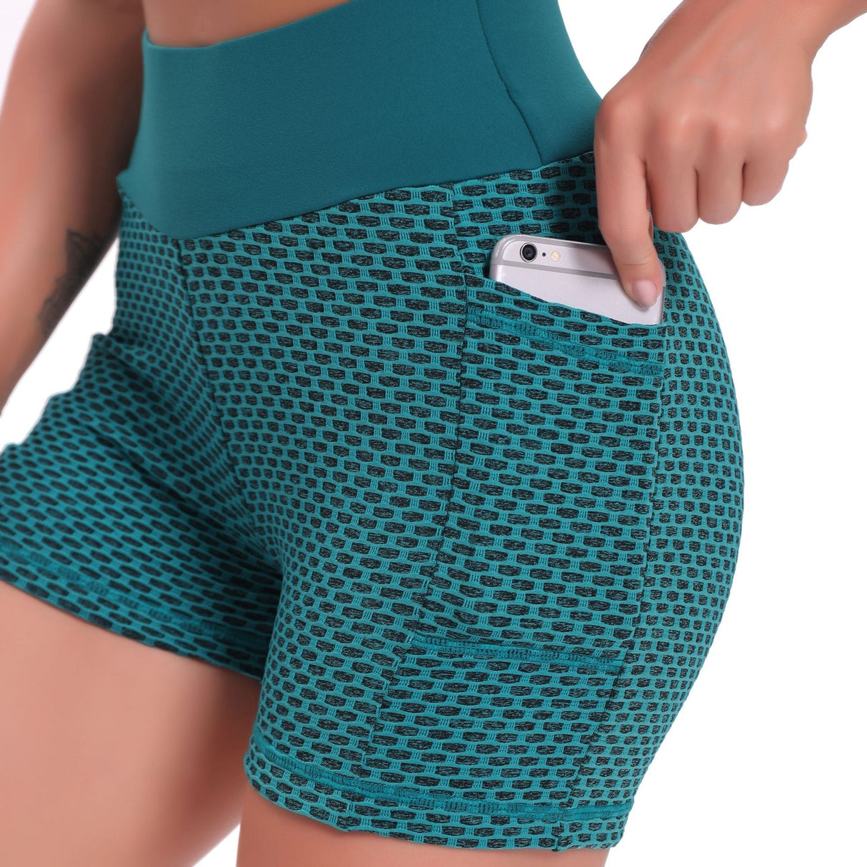 Green high-waisted yoga shorts in breathable jacquard with supportive compression design.