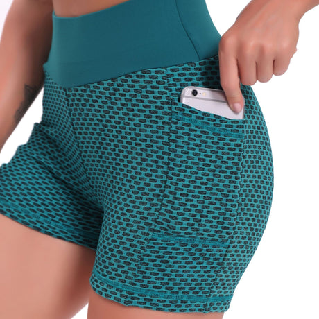 Green high-waisted yoga shorts in breathable jacquard with supportive compression design.