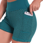 Green high-waisted yoga shorts in breathable jacquard with supportive compression design.