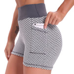 Grey high-waisted yoga shorts with jacquard weave and comfortable lifting support.
