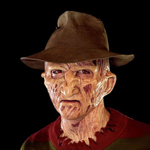 Zombiora mask with red eyes styled with a hat and burnt texture.