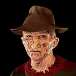 Zombiora mask with red eyes styled with a hat and burnt texture.