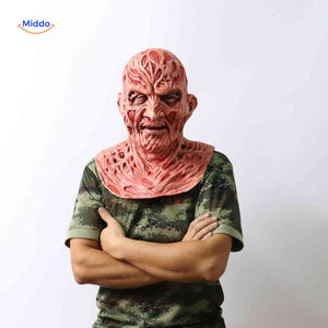 Person wearing Zombiora mask with camouflage shirt and arms folded pose.