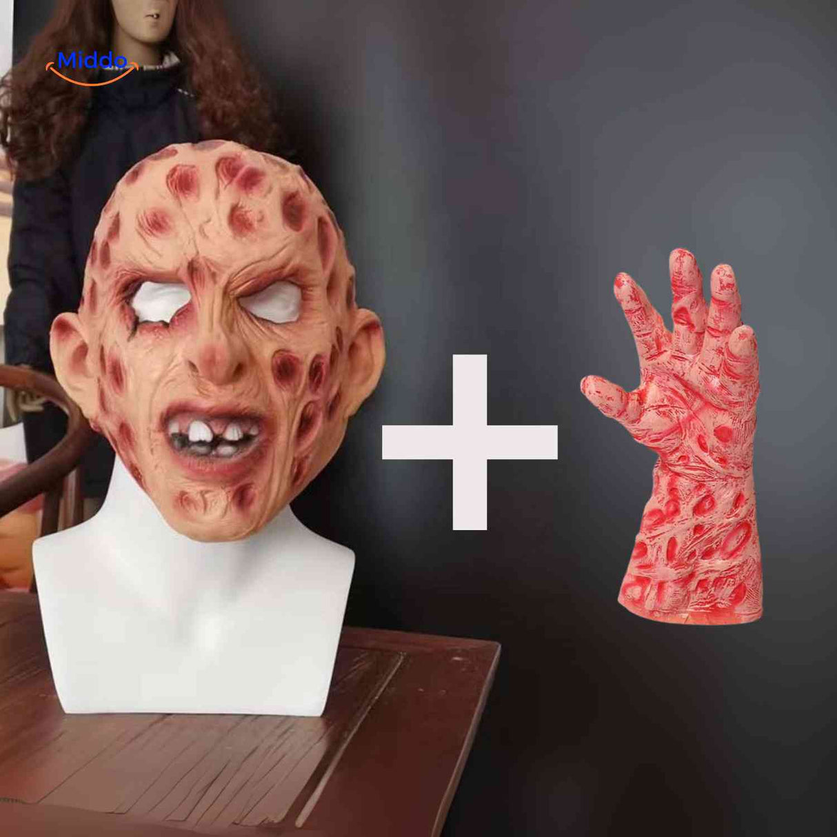 Zombie mask with red accents held by a bare hand without claws.