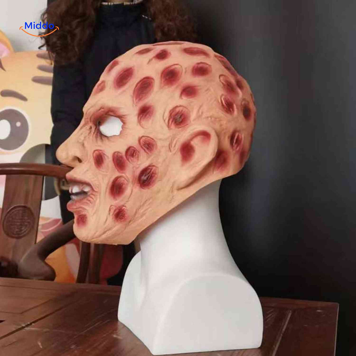 Side profile of Zombiora mask showing realistic texture and red accents.